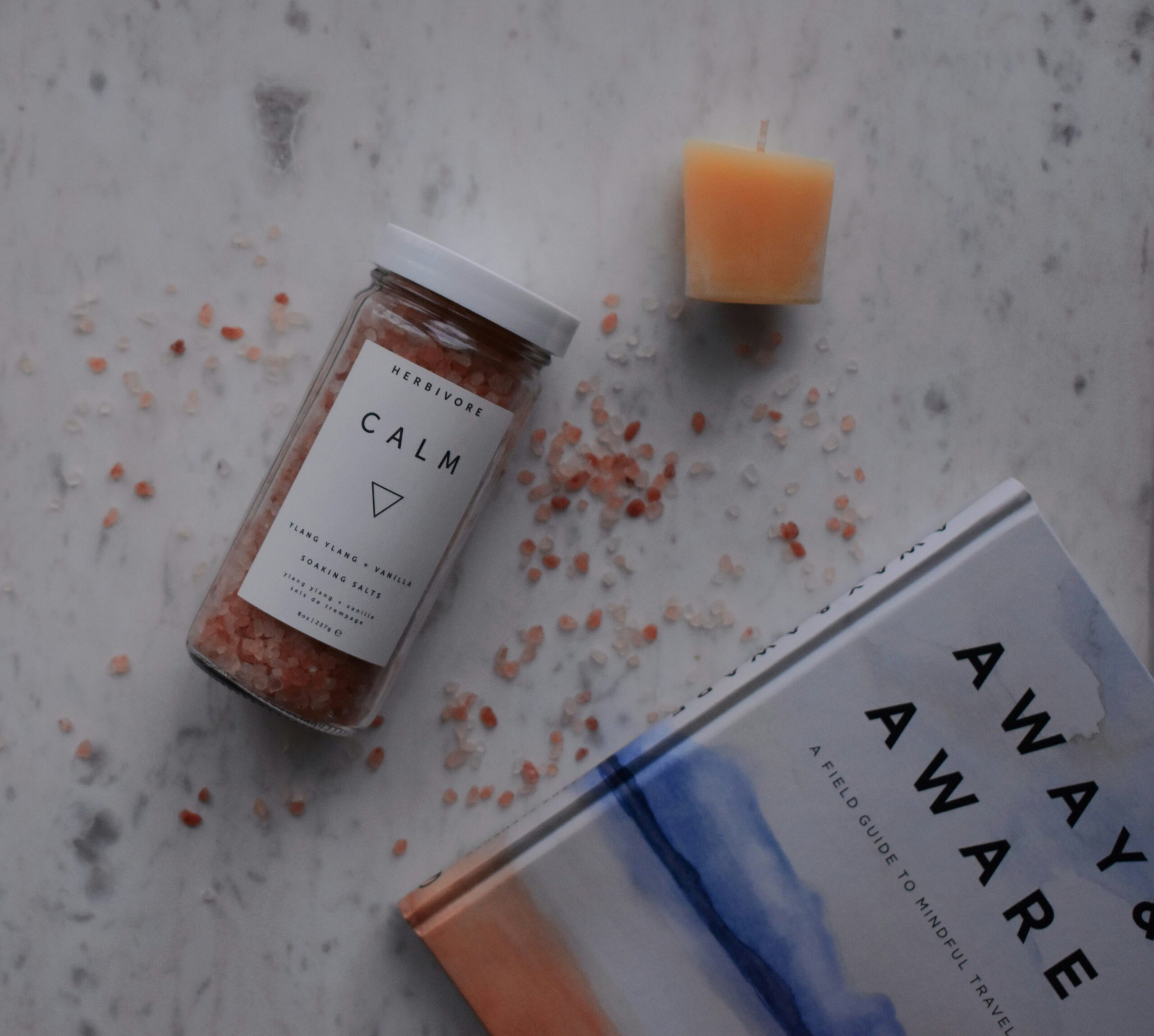 A calm wellness setting with herbal tea and a candle